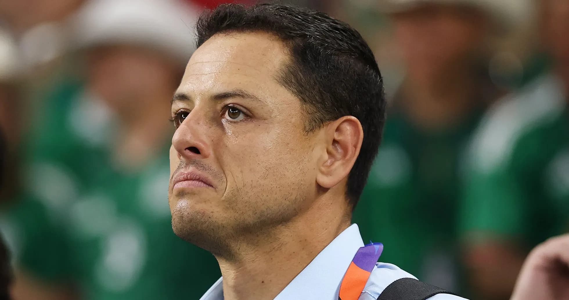 Man with tearful expression in crowd background