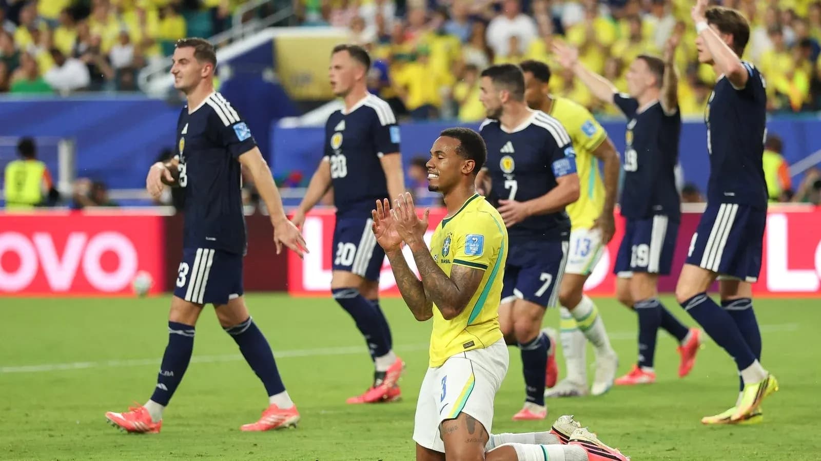 Brazilians celebrating while Scotsmen react in match