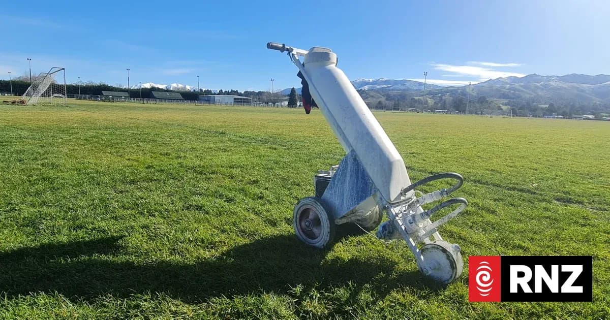 Line marking machine on a grassy football field