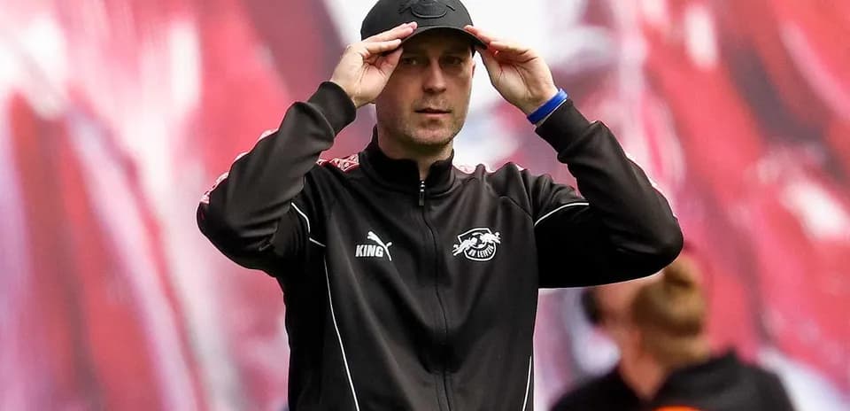 Coach adjusting cap during match warm-up