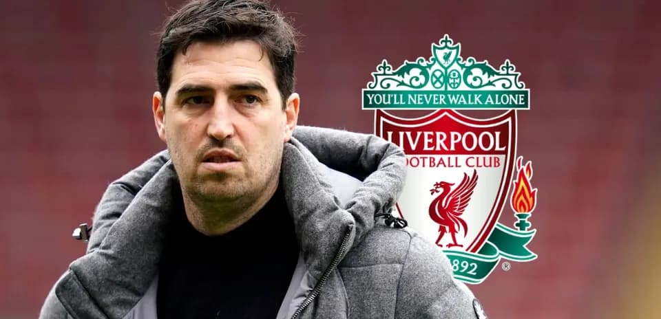 Coach standing in front of Liverpool logo