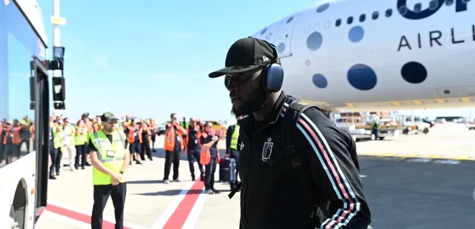 Player arriving at airport with team staff