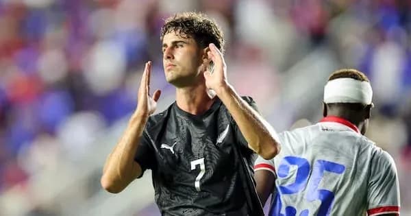 Player gesturing during soccer match on field