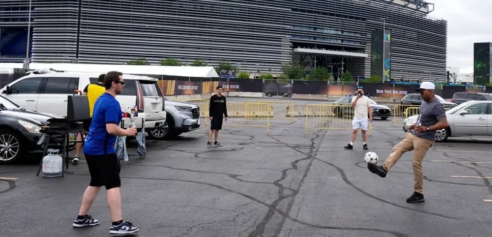 Group of people playing soccer in parking lot