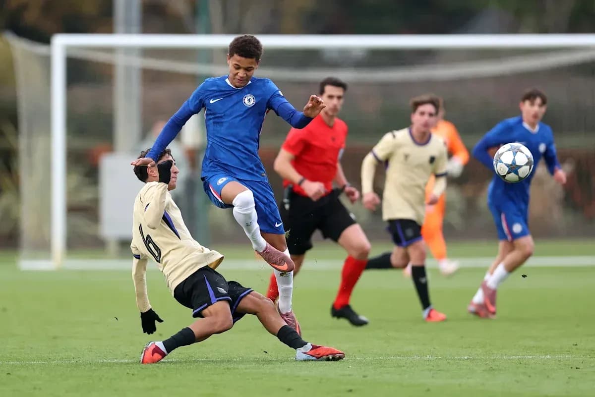 Player from Chelsea jumping over opponent on field