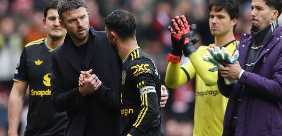Coach and player shaking hands on the pitch