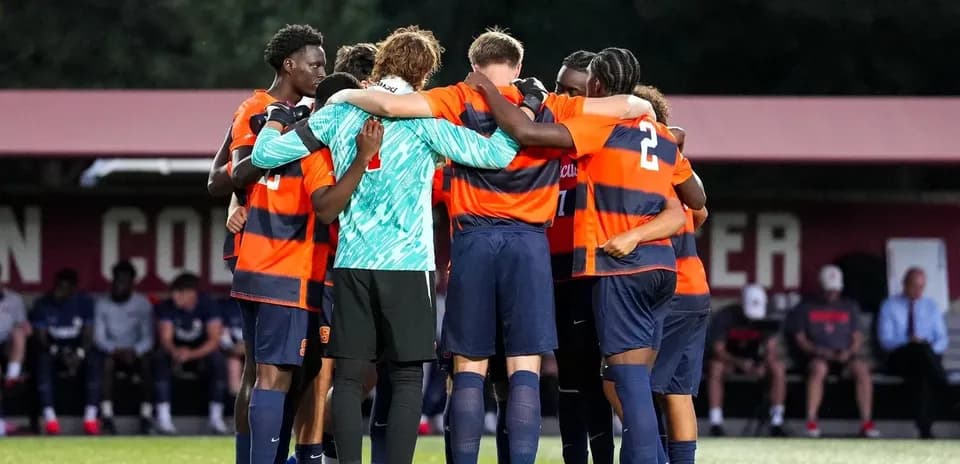 Syracuse players huddled before a match
