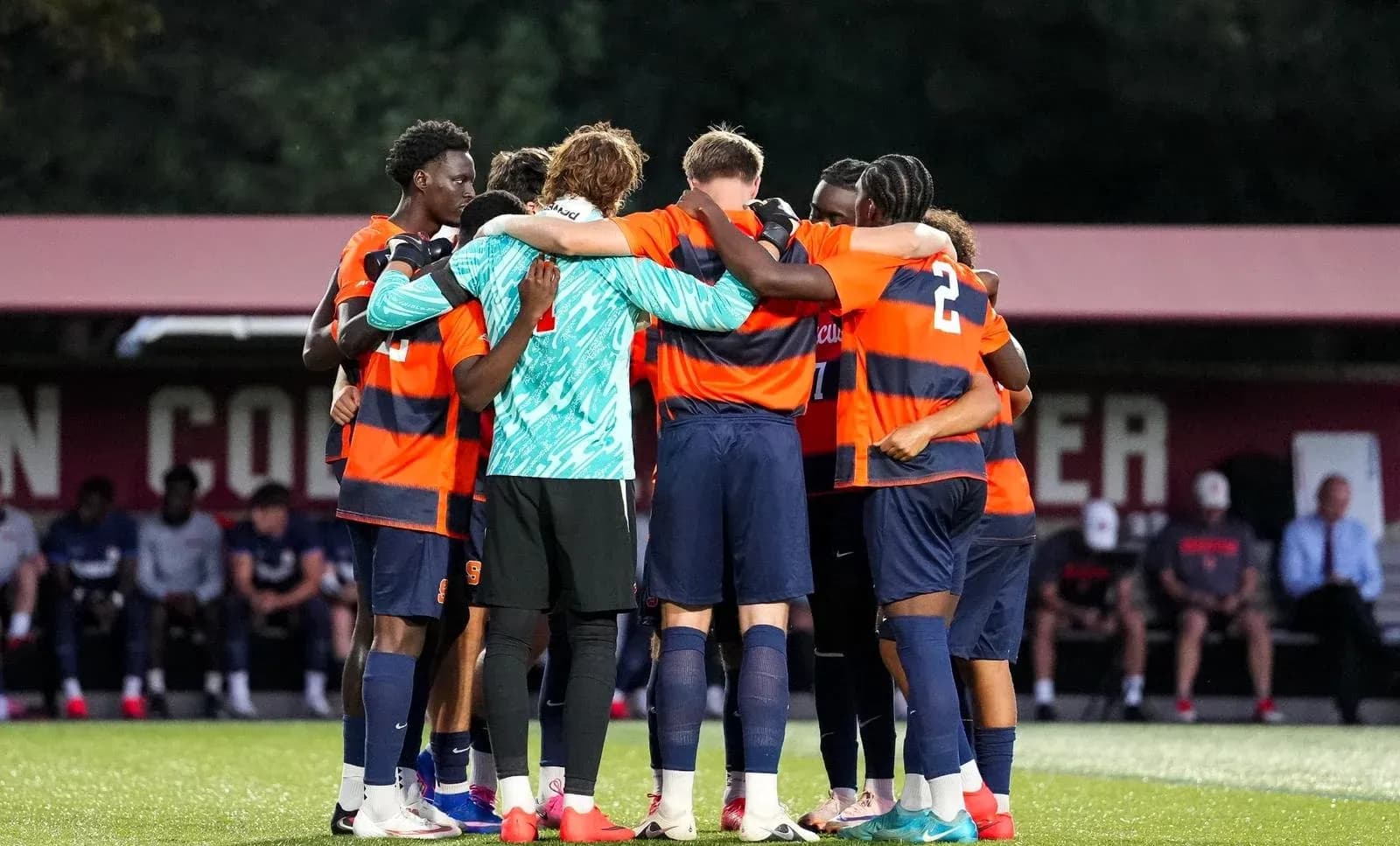 Syracuse players huddled before a match