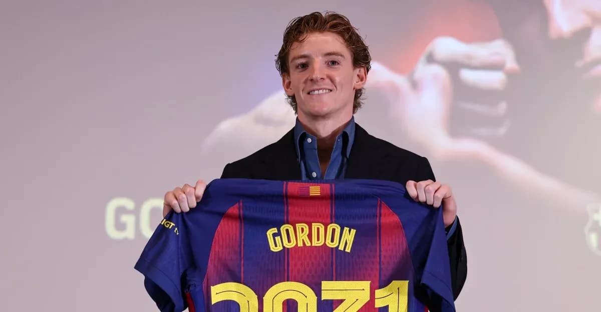 New player holding FC Barcelona jersey at presentation