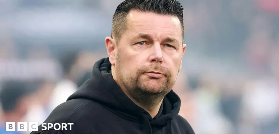 Men's football coach on the sidelines during match