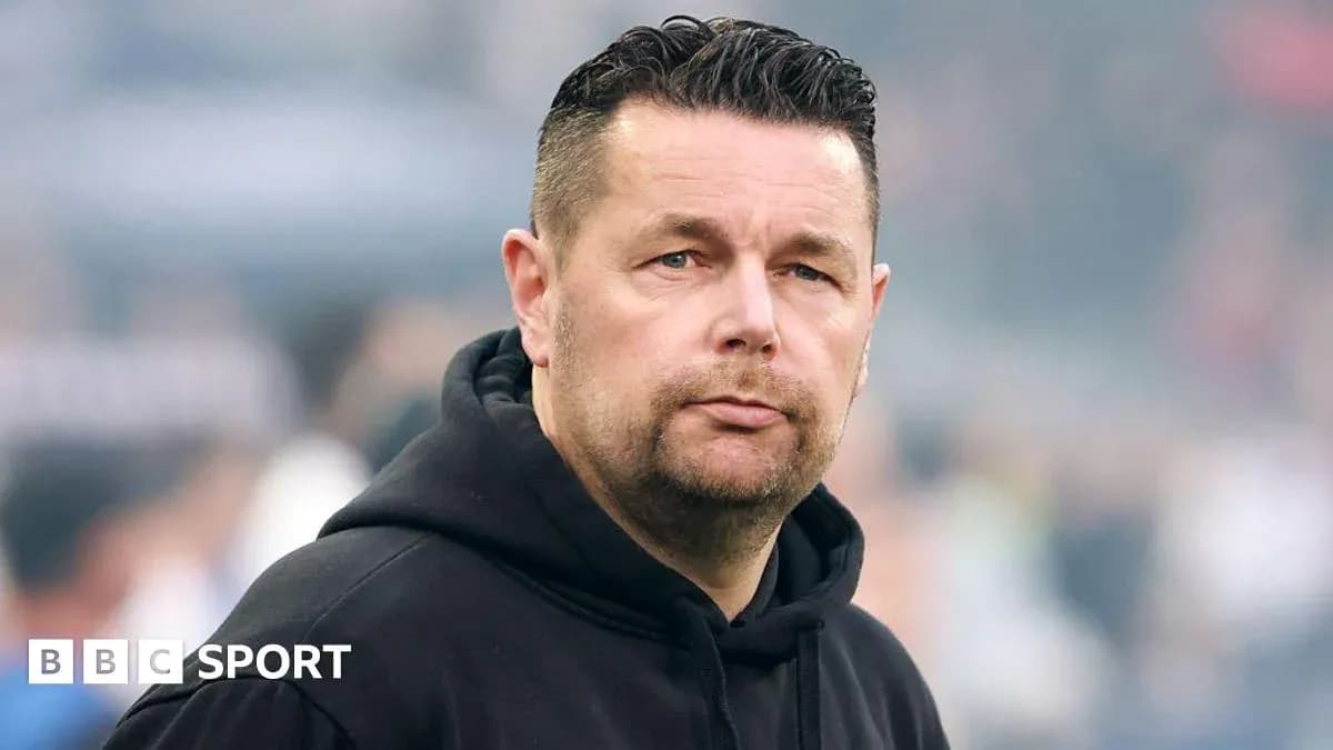 Men's football coach on the sidelines during match