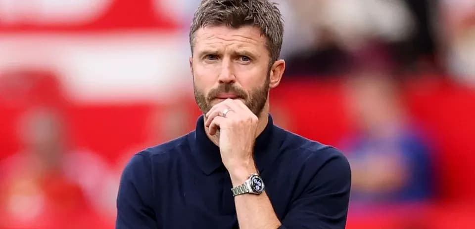 Men's football manager observing match from sidelines