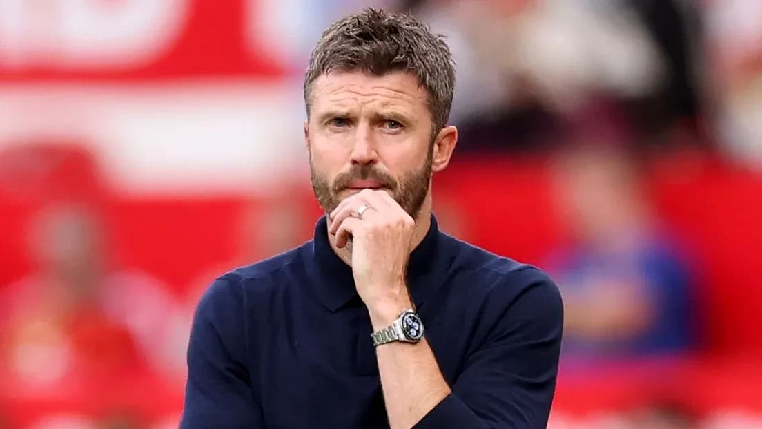 Men's football manager observing match from sidelines