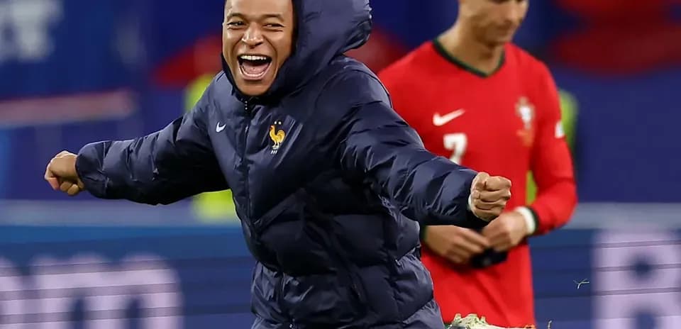 Kylian Mbappé celebrating with teammates on field