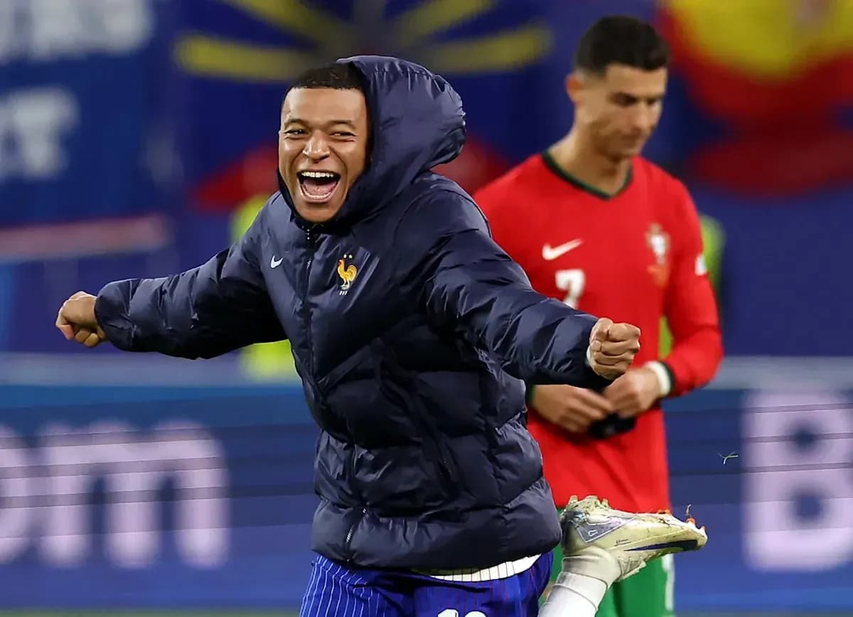 Kylian Mbappé celebrating with teammates on field