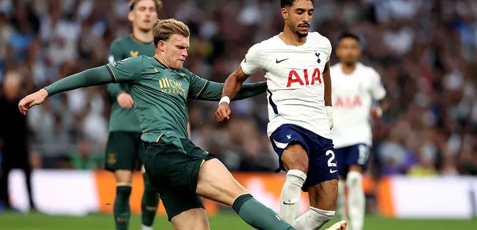 Tottenham player evading tackle during match action