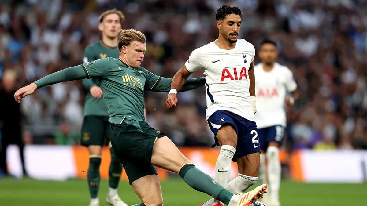 Tottenham player evading tackle during match action