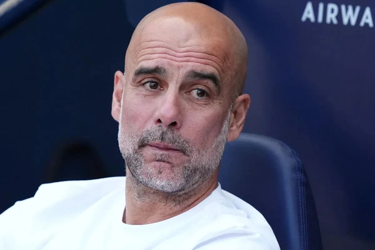 Football manager sitting on bench during match