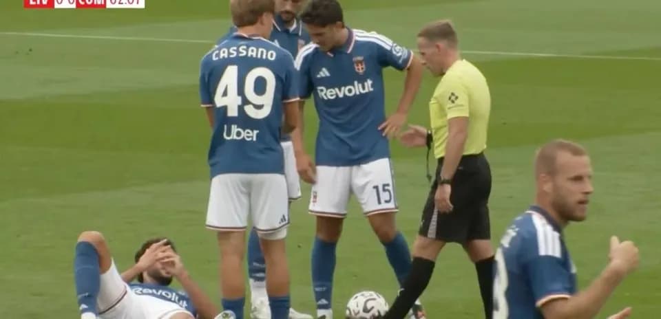Players gathered around injured teammate on pitch