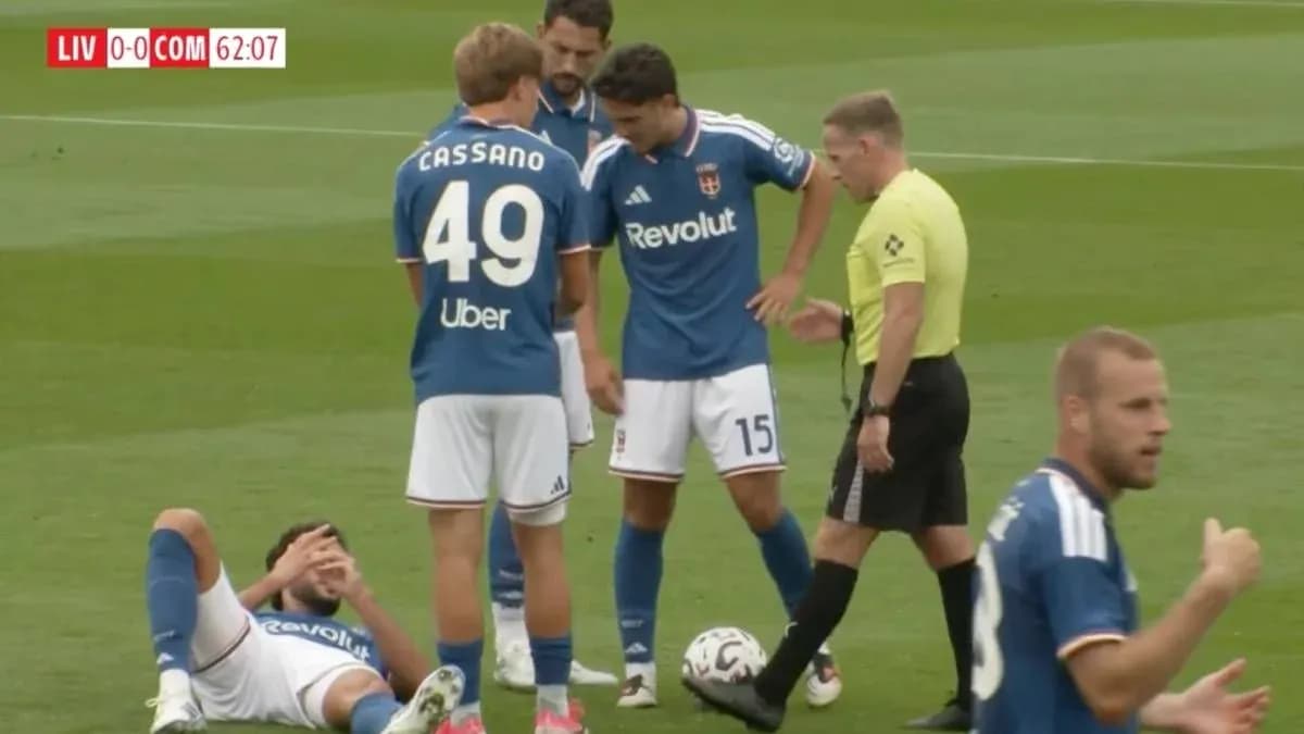 Players gathered around injured teammate on pitch