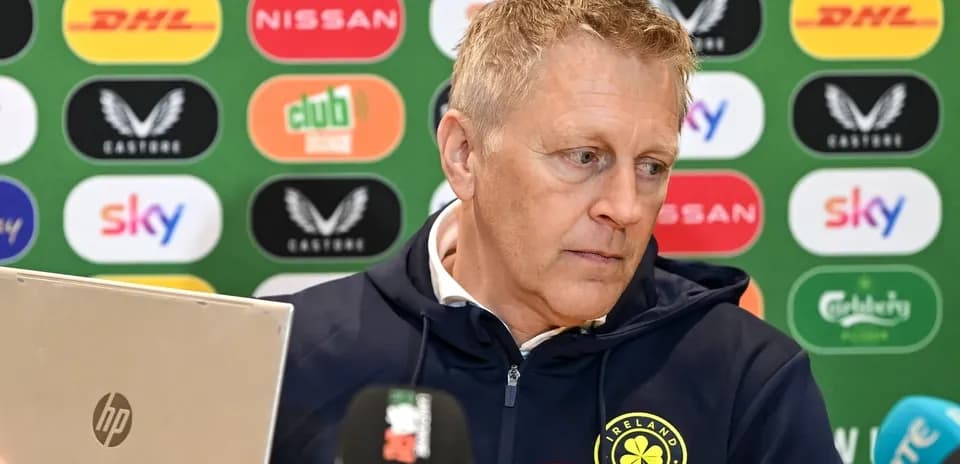 Men's football manager at press conference with laptop