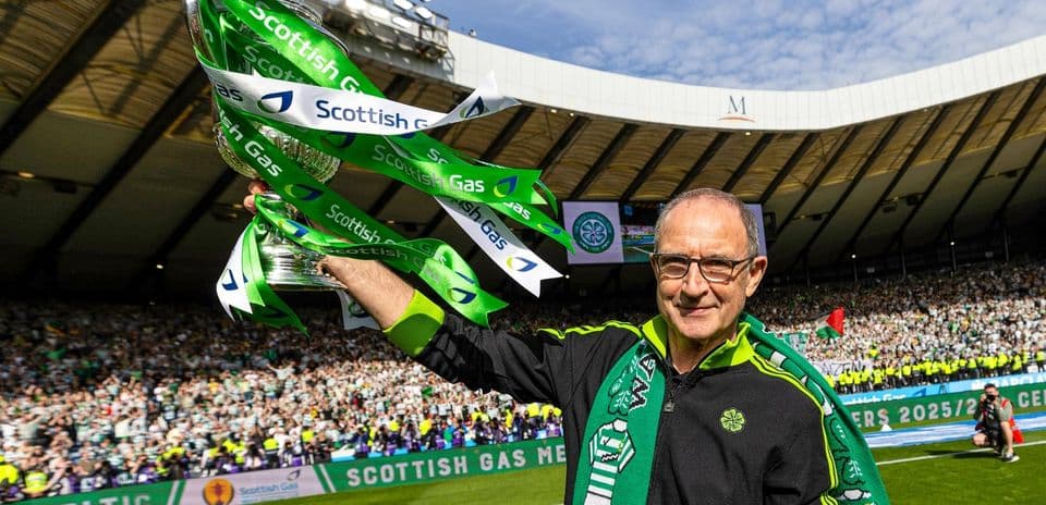 Fan celebrating with trophy at Celtic Park