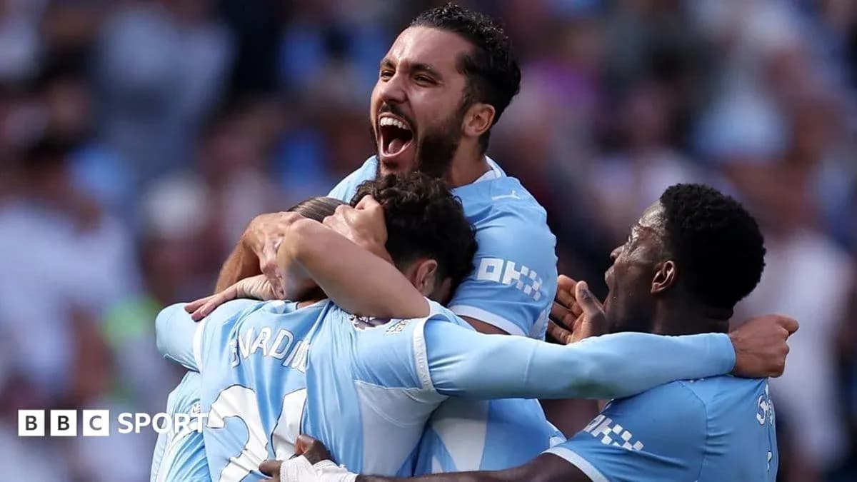 Manchester City players celebrating a goal together