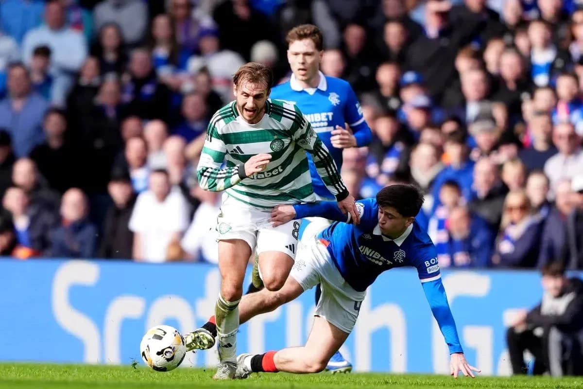 Celtic player evading tackle from Rangers opponent