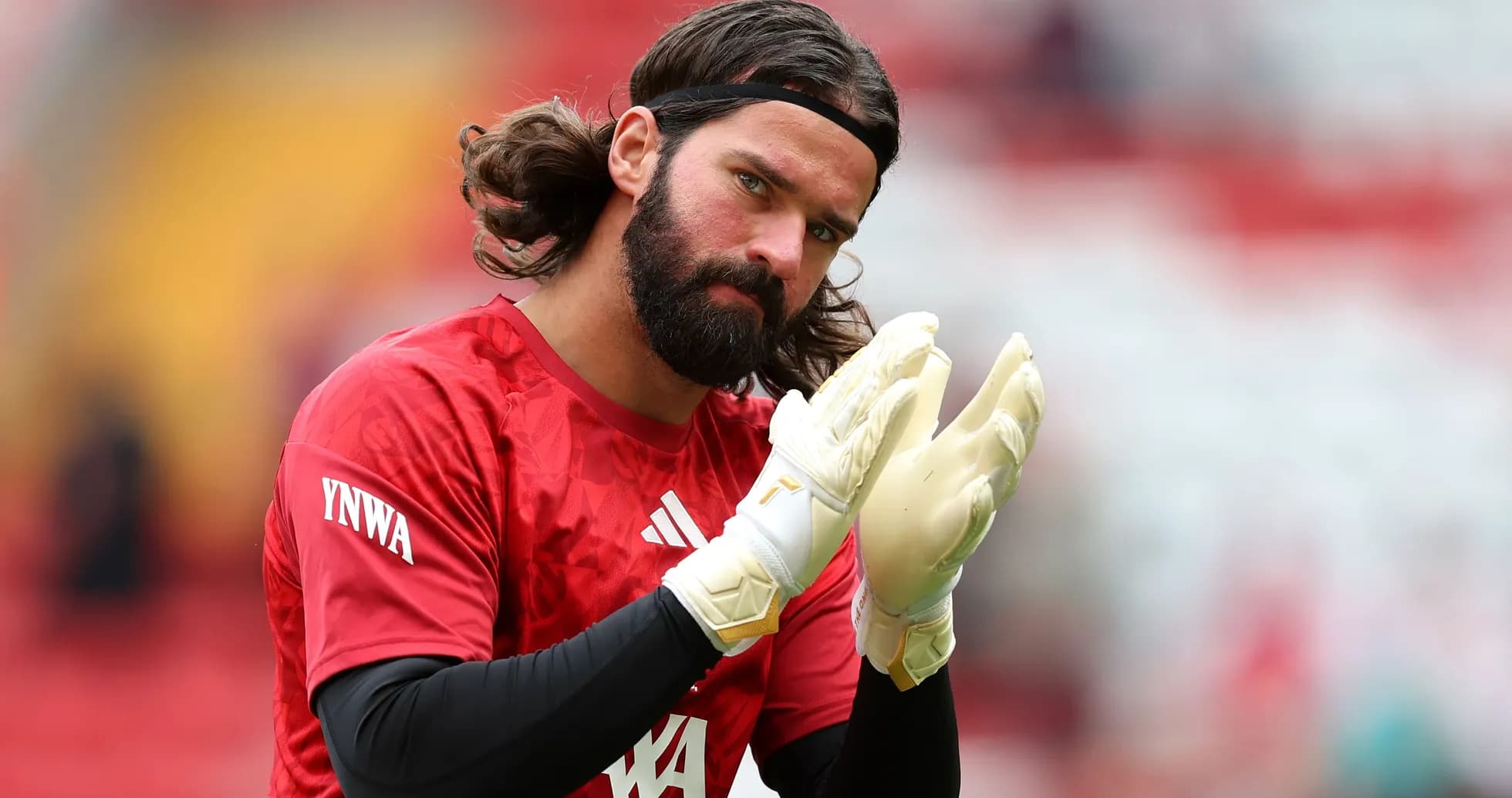 Goalkeeper applauding while wearing gloves during warm-up