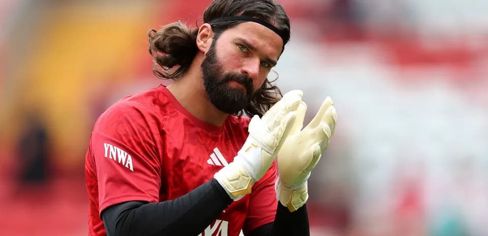 Goalkeeper applauding while wearing gloves during warm-up