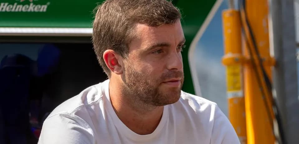Man sitting near racing team equipment
