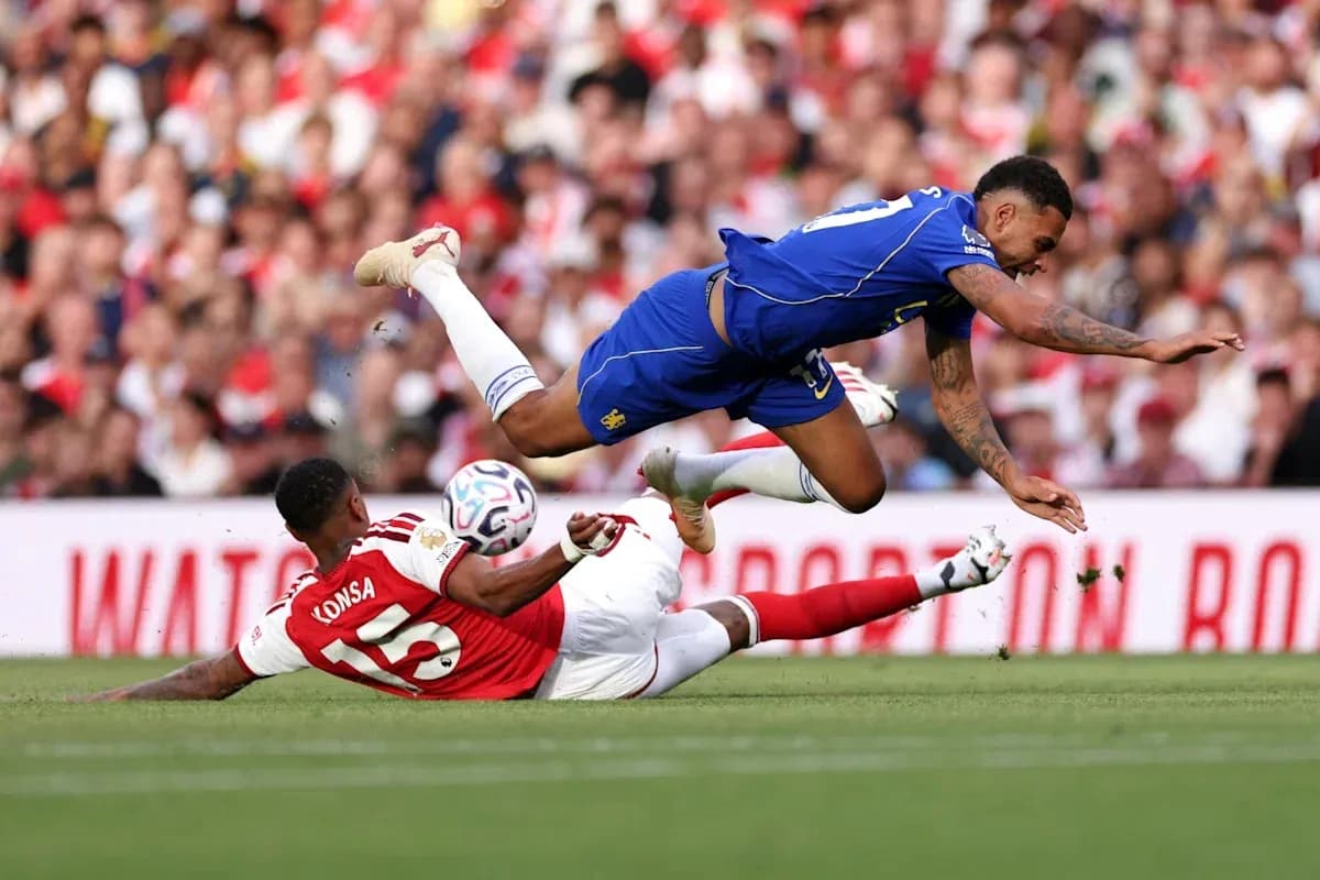 Player falling over opponent during football match