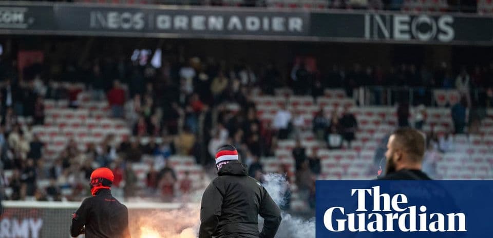 Supporters igniting flares in a stadium