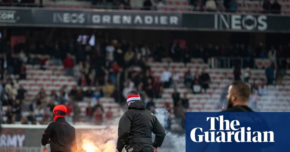 Supporters igniting flares in a stadium