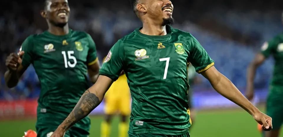 Two South African players celebrating a goal