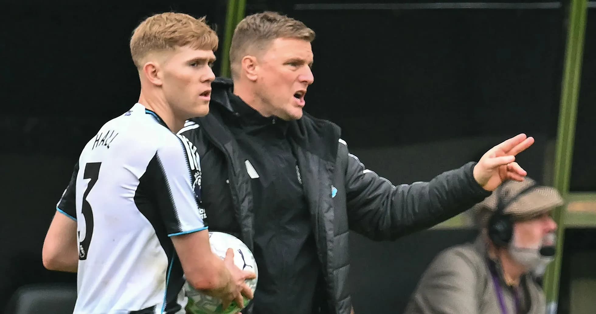 Newcastle player receiving instructions from coach