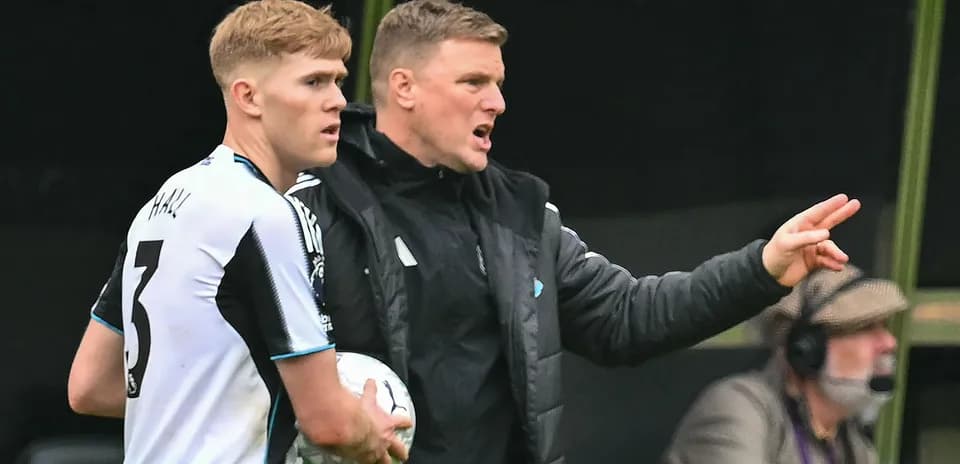 Newcastle player receiving instructions from coach