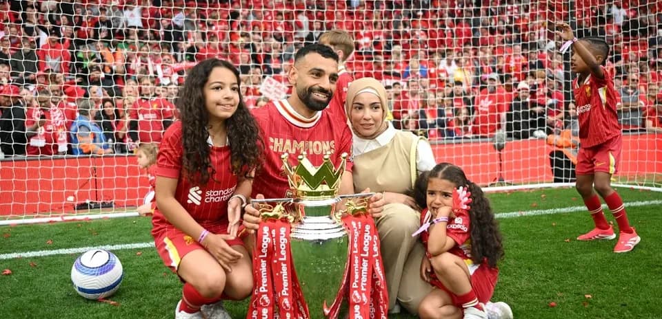 Mohamed Salah celebrating with family and trophy