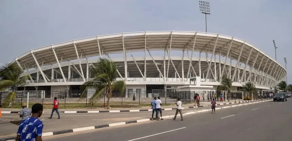 Stadium exterior with pedestrians on the street