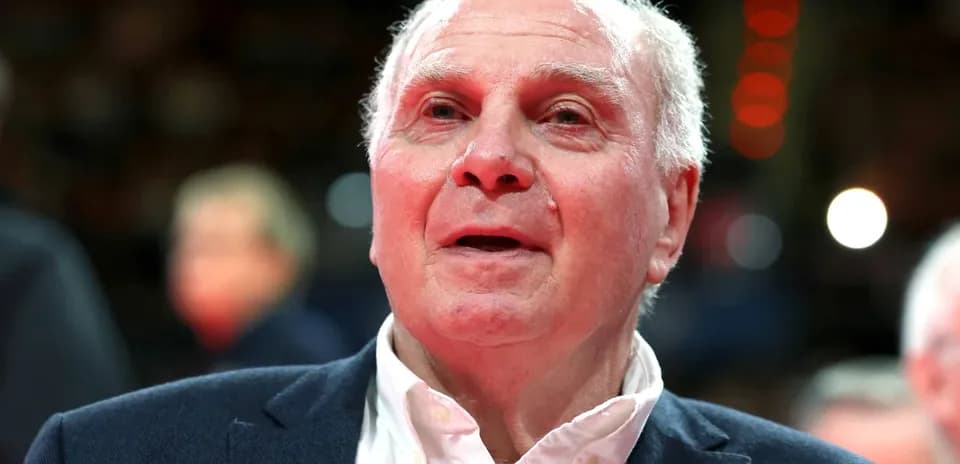 Elderly man in suit at sporting event