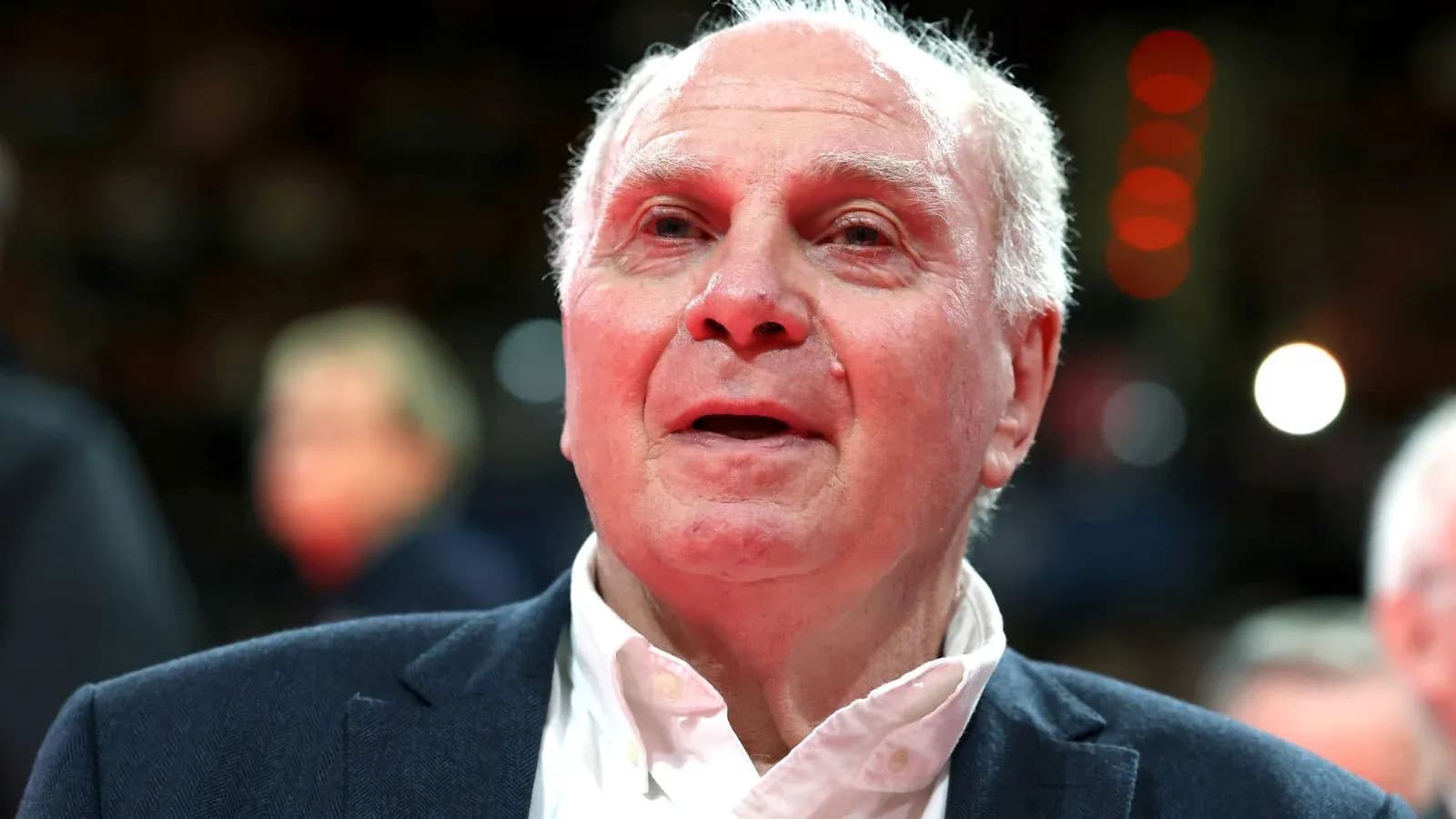Elderly man in suit at sporting event