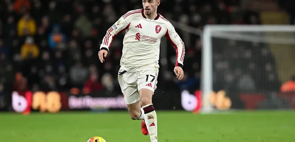 Player in white kit running with the ball