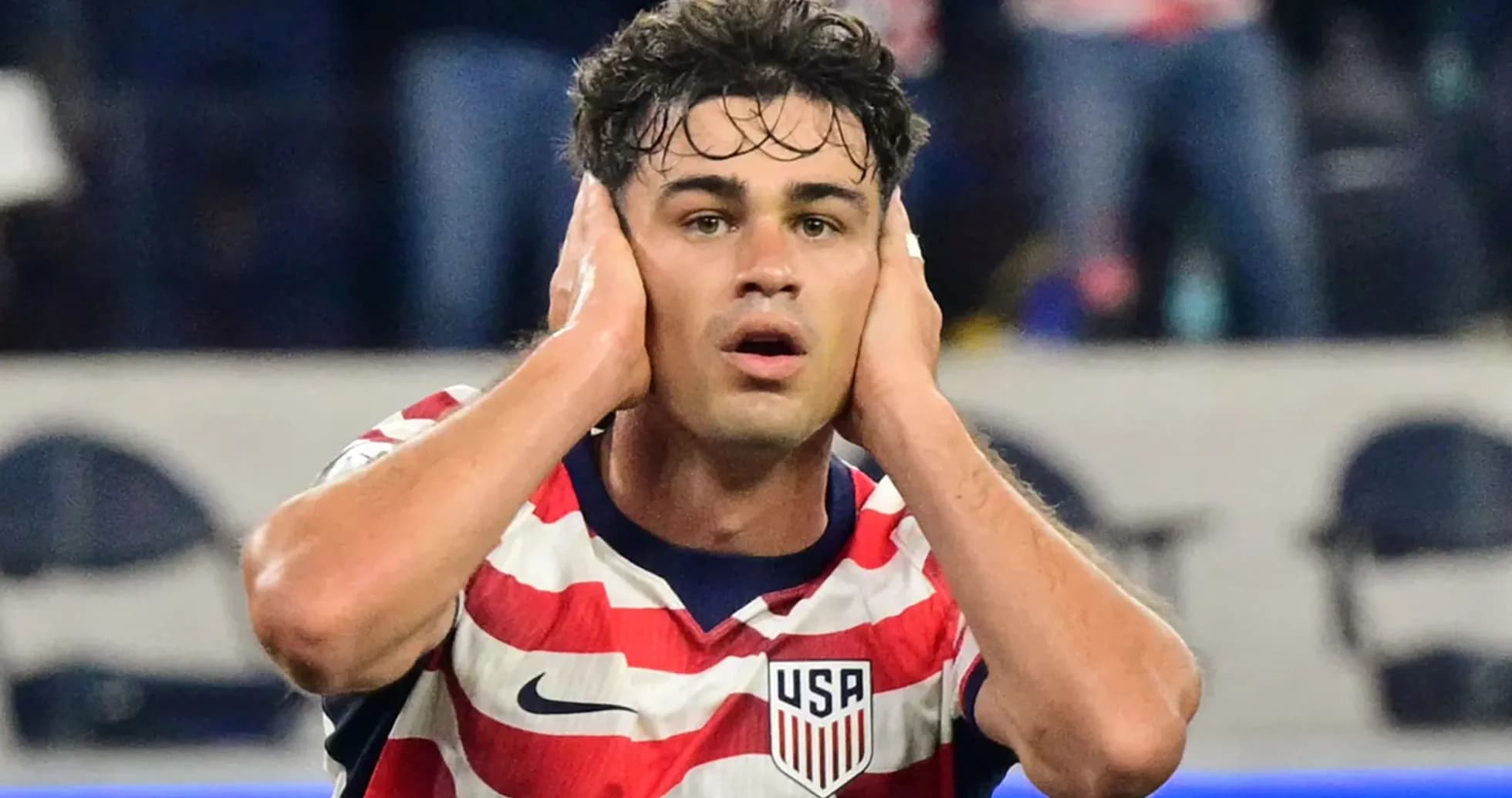 Player reacting during match, hands on head