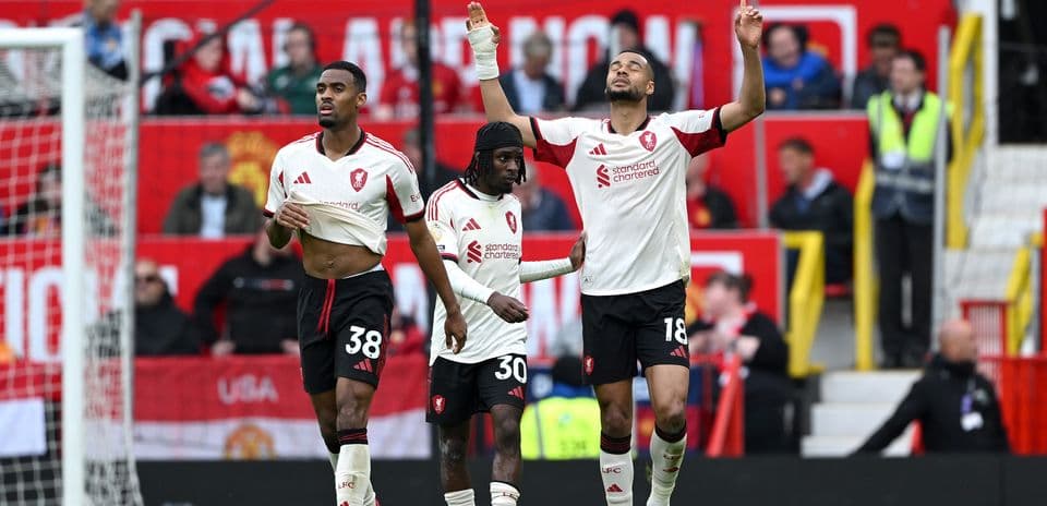 Three players celebrating during a match at Old Trafford
