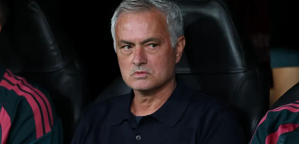 Head coach sitting on bench during match