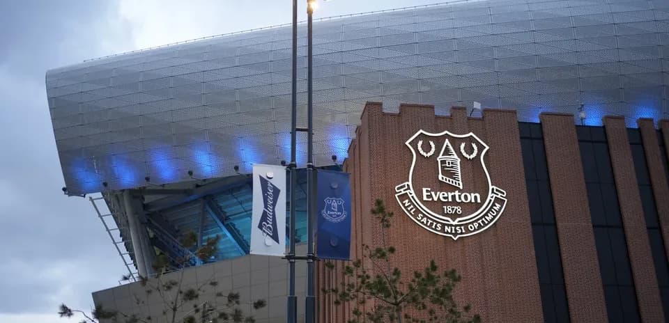 Everton Stadium exterior with club logo and banners