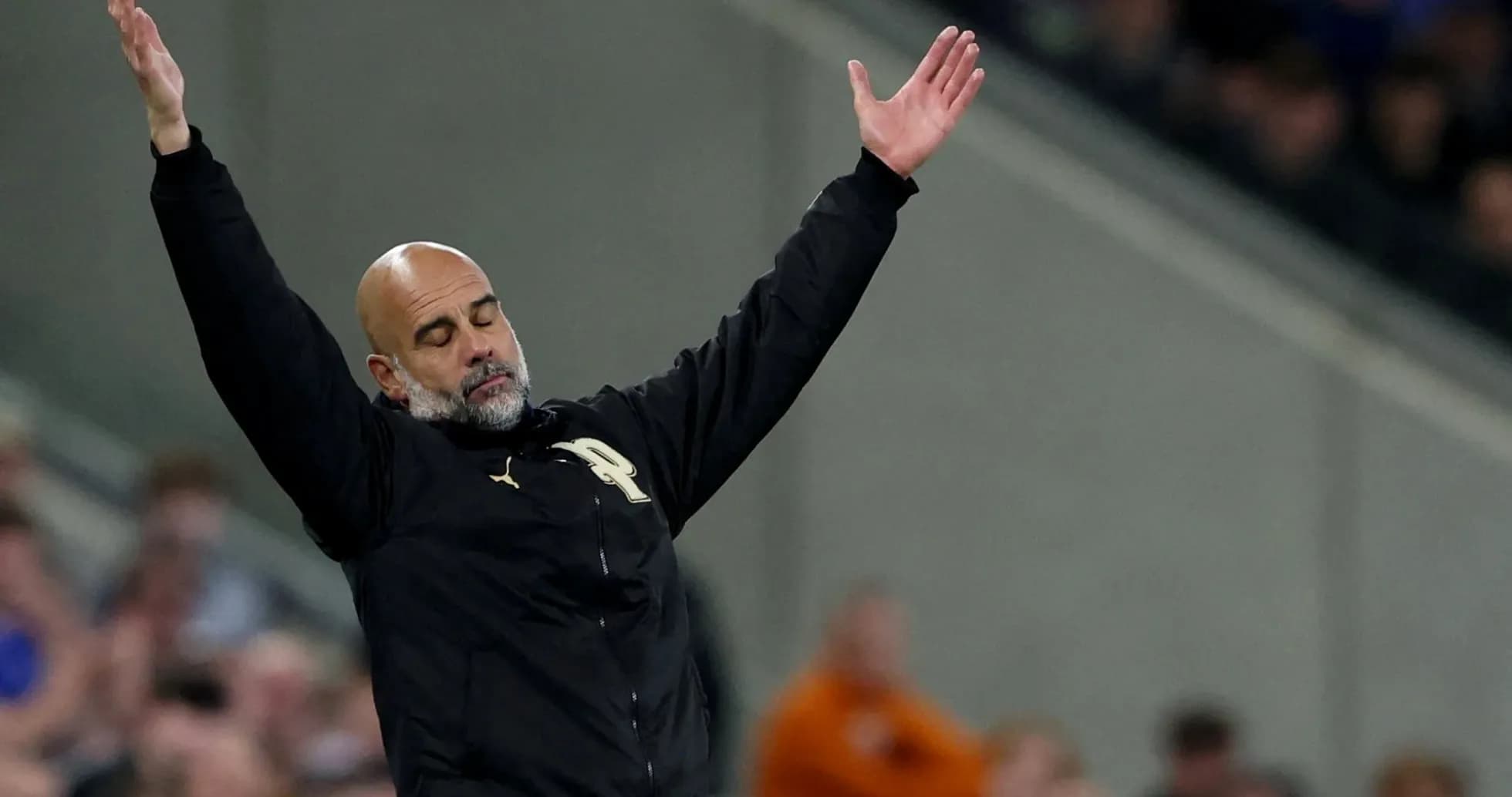 Manager gesturing during a match on the sidelines