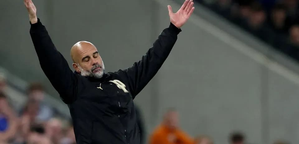 Manager gesturing during a match on the sidelines