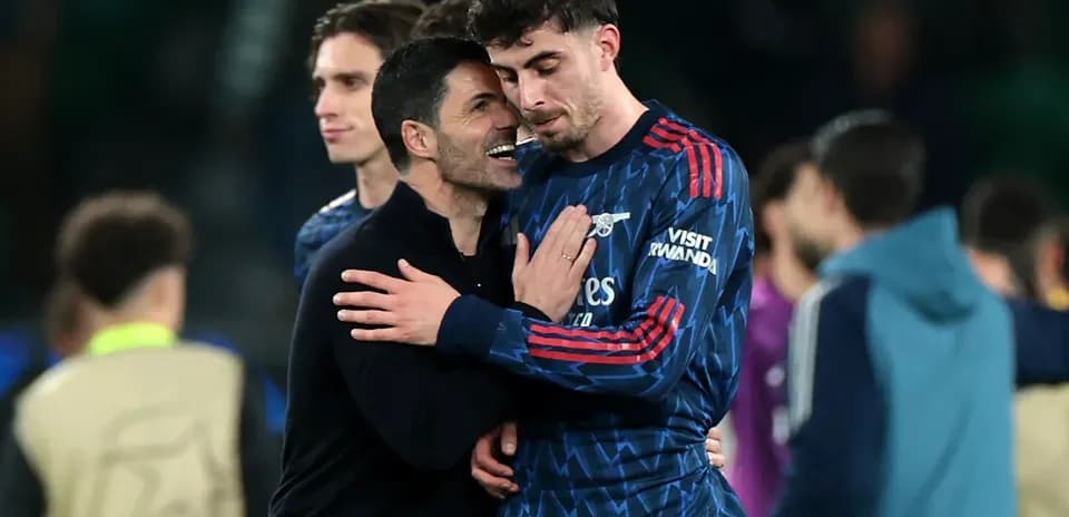 Arsenal coach celebrating with player after match