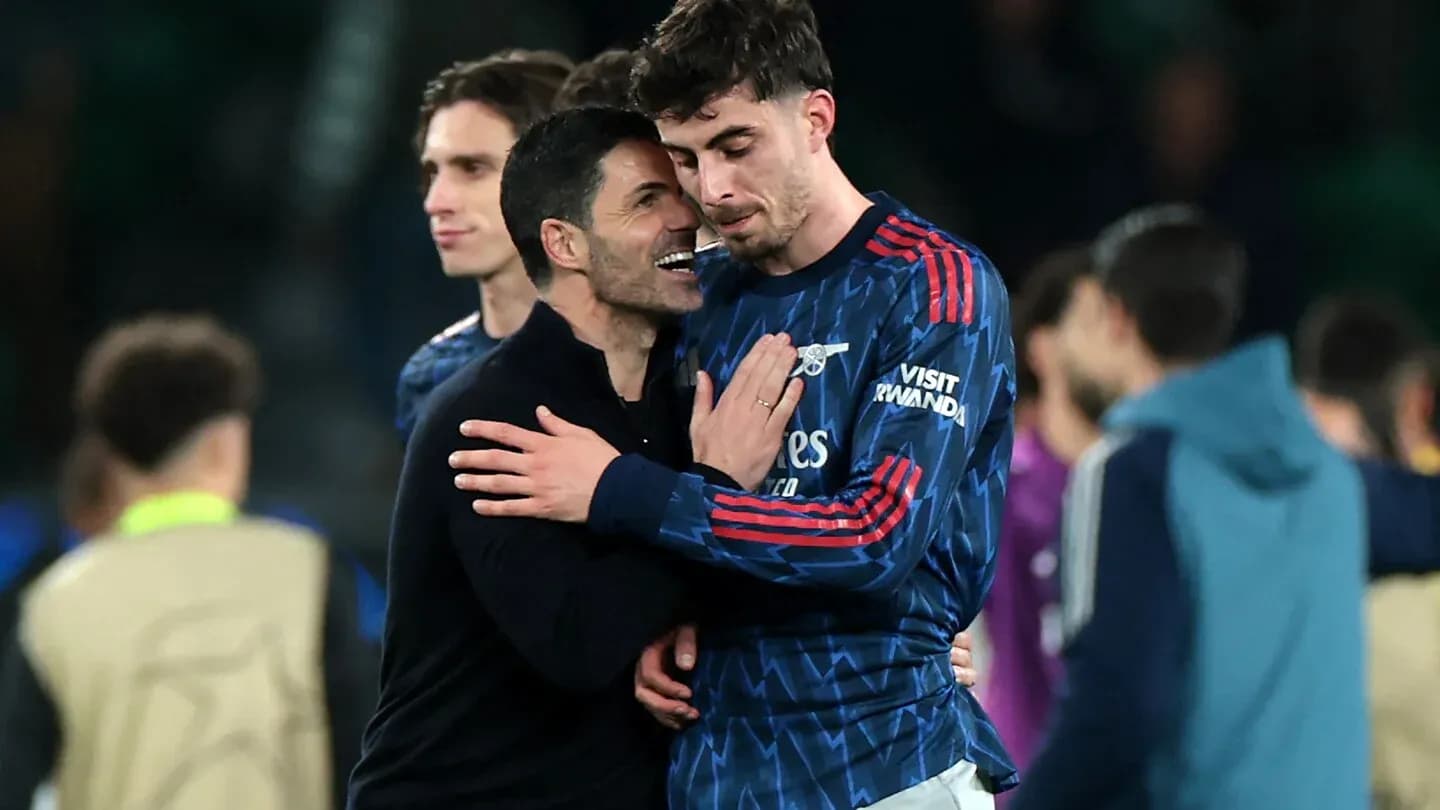 Arsenal coach celebrating with player after match